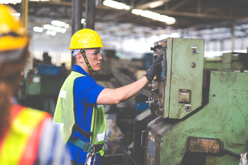 Mechanical Engineering control lathe machine in factory facility. Safety First at work place.