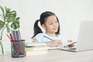 pretty  stylish schoolgirl studying homework during online lesson at home, social distance during quarantine, self-isolation, online education concept, home school, study online video call teacher.