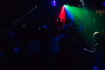 Fototapeta na wymiar people dancing in a nightclub on the dance floor