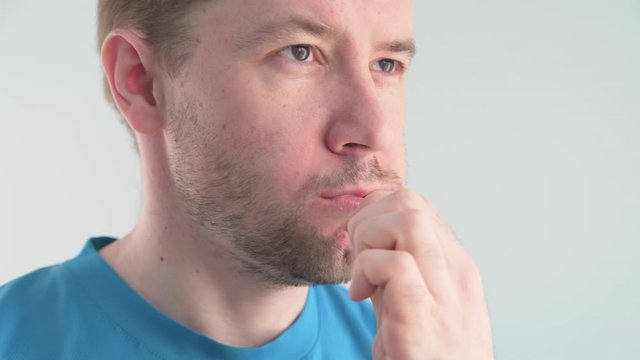 Adult Caucasian man brushes his teeth with a bamboo toothbrush in a light bathroom. zero waste concept.