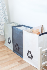 Bags for paper,  plastic, glass on the kitchen, garbage sorting save earth concept, vertical