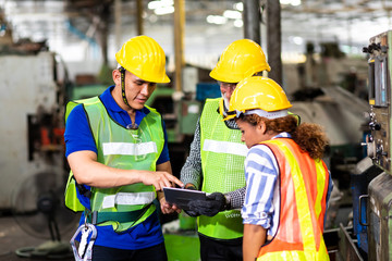 Professional Mechanical Engineer team Working on Personal Computer at Metal lathe industrial manufacturing factory. Engineer Operating  lathe Machinery. Product quality Inspection