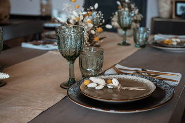 festive table setting. glass dishes. rustic retro style. with flowers.
