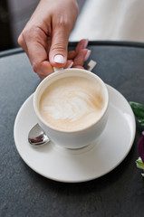 cup with cappuccino coffee