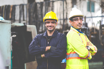 Two electrician Man Worker at industrial factory wearing uniform and hard hats and Mechanical repair.  Engineer Operating  lathe Machinery