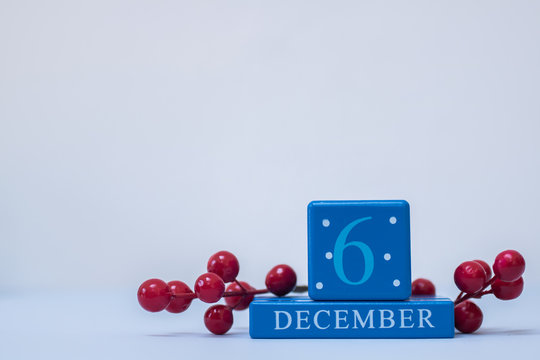 A seasonal clean Christmas-themed scene in blue and red with calendar blocks for 6 December date
