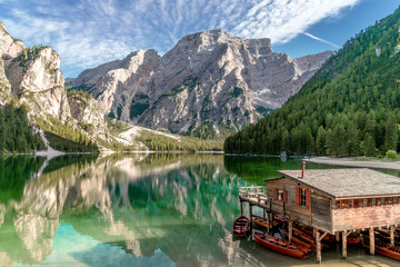 Sunset mountain reflections and the boathouse at the Pragser Wildsee, Lake Prags, Lake Braies, South Tyrol, Italy 