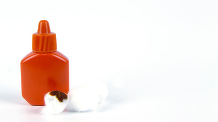orange bottle  containe antiseptic and cotton for cleaning wounds.