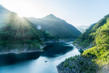Rowers at a beautiful italian mountain lake