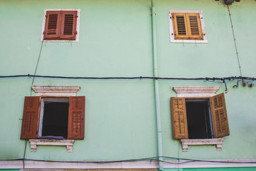 Obraz na płótnie Canvas bright green house with open shutters in Pula, Istrian Peninsula in Croatia