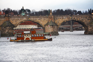 Boating in the Vitava river near the Charles bridge in Prague