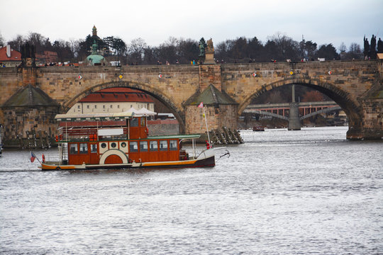 Boating in the Vitava river near the Charles bridge in Prague
