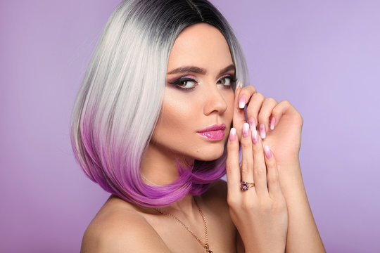 Ombre bob short hairstyle. Woman portrait with blond purple hair and manicured nails. Beauty makeup. Beautiful girl model isolated on violet background.