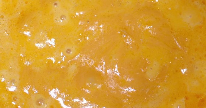 Fondue of fragrant cheese is boiling in the pot.