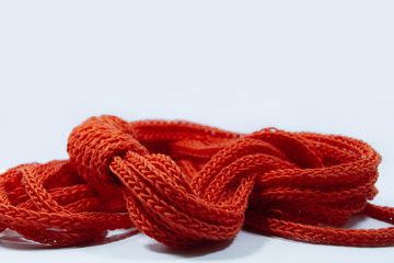Orange spool knitted cord scarf isolated