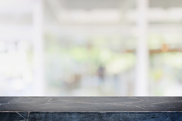Empty black marble stone table top and blur glass window interior cafe and restaurant banner mock...