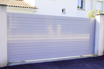 white street home door aluminum gate slats portal of suburb house