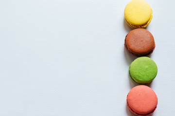 Colorful macaroons. French dessert multicolored cake on a white background. Fragrant dessert.