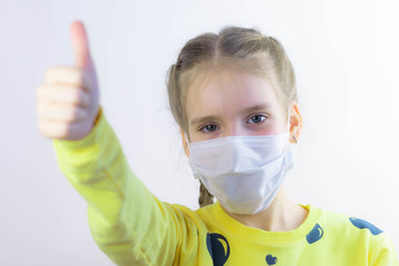 Glad and happy beautiful joy,child in the medical helthcare guarding or protecting mask and in yellow t-shirt on the white background for easy extraction