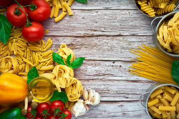 Still life of tortellini, tagliatelle, tortiglioni, fusilloni, casarecce, spaghhetti, macoroni, tomato, mushroom, pepper, olive oil