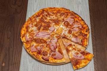 top view of homemade pizza on a wooden table. home kitchen