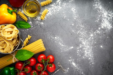 Still life of tortellini, tagliatelle, tortiglioni, fusilloni, casarecce, spaghhetti, macoroni, tomato, mushroom, pepper, olive oil
