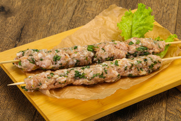 Raw minced pork skewer kebab for grill