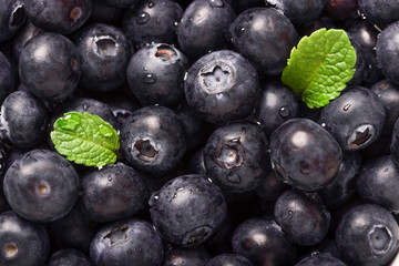 Loose fresh blueberries with small bits of mint leaves