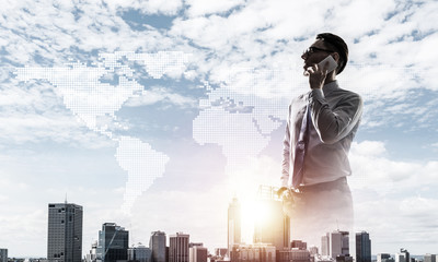 Concept of business success and control with confident boss against cityscape background