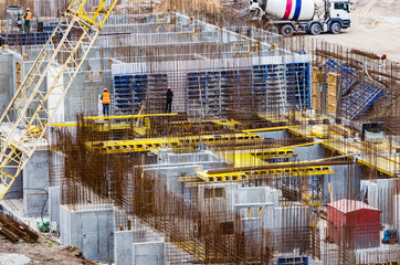 Construction workers install formwork and iron rebars or reinforcing bar for reinforced concrete...