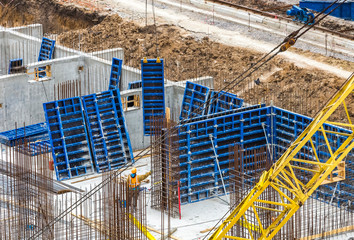 Construction workers install formwork and iron rebars or reinforcing bar for reinforced concrete...
