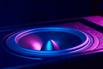 Sound audio speaker with neon lights on dark background. Dynamic monitor close up. Creative...