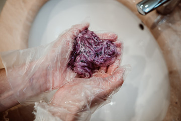 Obraz premium .Young woman coloring her white hair in her bathroom. Hairdressers closed due to quarantine caused by covid19. Lifestyle