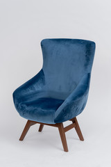 blue velor chair with wooden legs