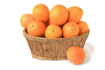 Oranges in a wooden basket and a whole orange isolated on white