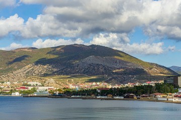 Panorama of resort town from Cape Alchak. City is located in valley between mountains. Velvet season in one of pearls of southern coast of Crimea. Sudak, Crimea, Russia - October 2, 2019.