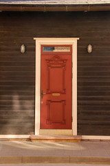 Framed front door and two lanterns. Beautiful entrance door front view. 