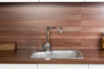 chrome tap and sink in a rustic kitchen
