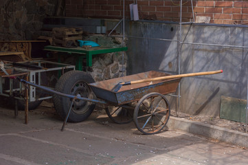 Fototapeta na wymiar Wheelbarrow and shovel in domestic backyard