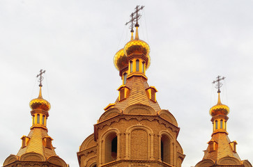 Fototapeta na wymiar Christian church, golden domes, sunny day, toned