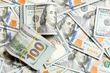 Many Stack of 100 dollar bills on dollars background top wiev with copy space