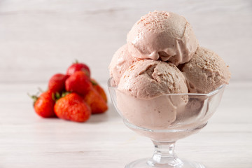 Strawberry ice cream in a flask on a light background