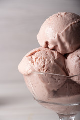 Strawberry ice cream in a flask on a light background