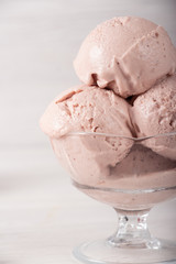 Strawberry ice cream in a flask on a light background