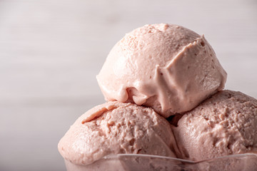 Strawberry ice cream in a flask on a light background