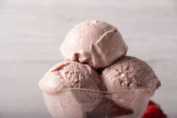 Strawberry ice cream in a flask on a light background