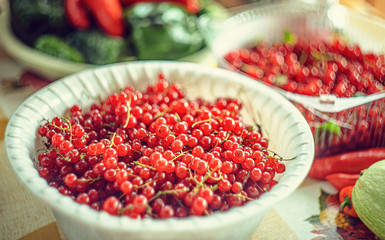 Red currant berries in a bowl on the table, harvest
