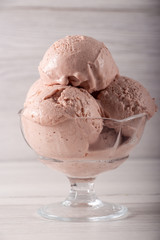 Strawberry ice cream in a flask on a light background