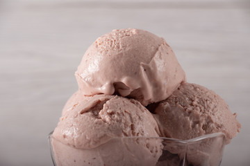 Strawberry ice cream in a flask on a light background