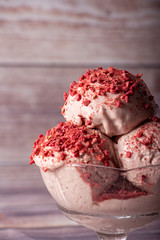 Strawberry ice cream in a flask on a light background